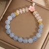 Light blue aquamarine and white agate abacus bead bracelet with a pink flower charm