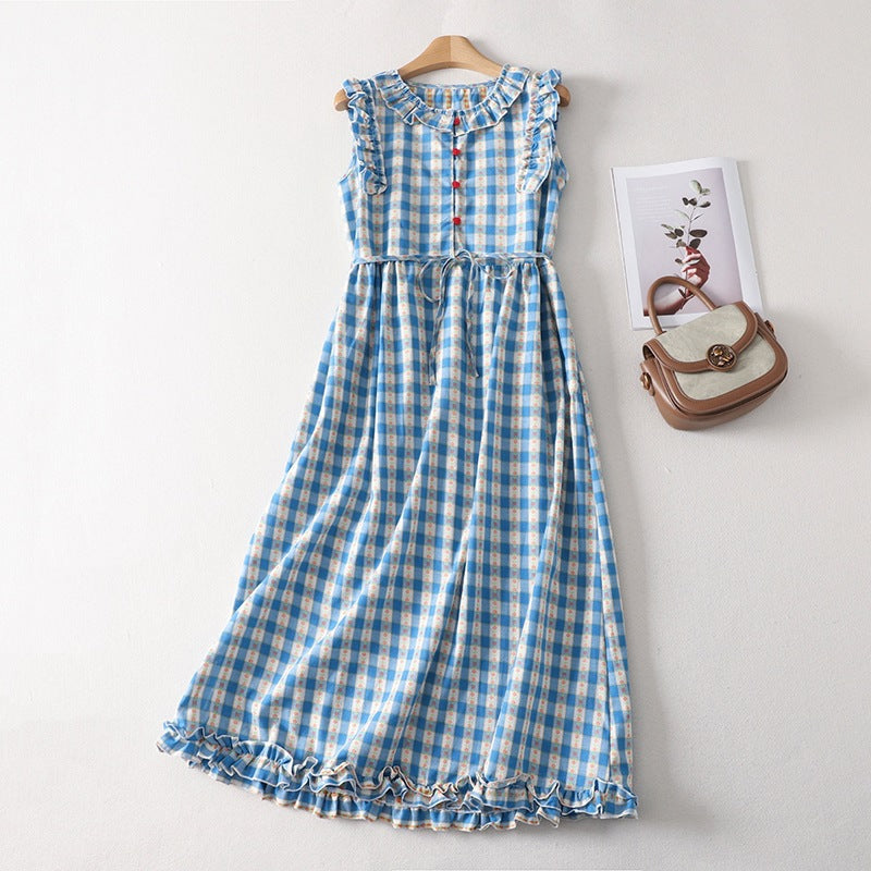 Blue and white gingham sleeveless dress hanging on a wooden hanger