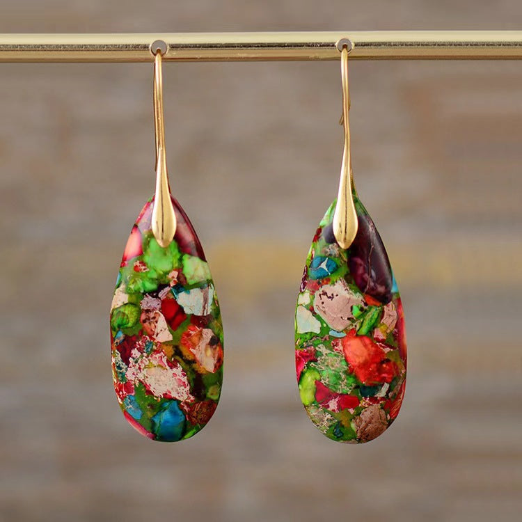 Pair of multicolor Emperor Stone teardrop earrings hanging from a gold rod