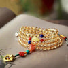 Close up of yellow citrine mala bracelet wrapped around wrist
