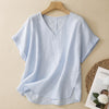 Light blue cotton V-neck short sleeve top on a wooden hanger