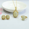 Gold-tone jewelry set with pale green Hetian jade stones including a pendant, ring, and earrings