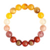 Hand wearing a polished red and yellow crystal bracelet with gold accents