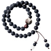 Double layer matte black wood bead bracelet with carved animal charm worn on wrist