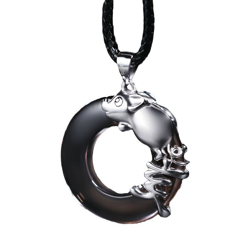 Silver tone rat charm pendant on a black cord against a dark background