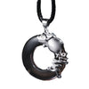 Silver tone rat charm pendant on a black cord against a dark background