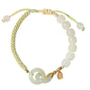 Close up of a natural jade double peace buckle bracelet on a woven green cord