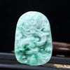 Close up of a light green carved jade dragon pendant