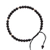 Close up of small black obsidian beads on a fulfillment rope bracelet with a gold accent