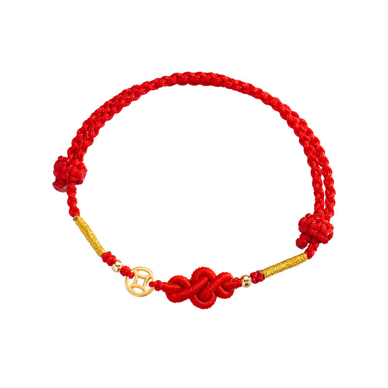 Close-up of a red braided bracelet with a Ruyi knot and gold coin charm on a white background