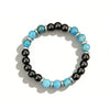A beaded bracelet featuring blue and black natural stones with silver spacers on a white background