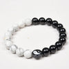 Close up view of black obsidian and white turquoise yin yang bracelet