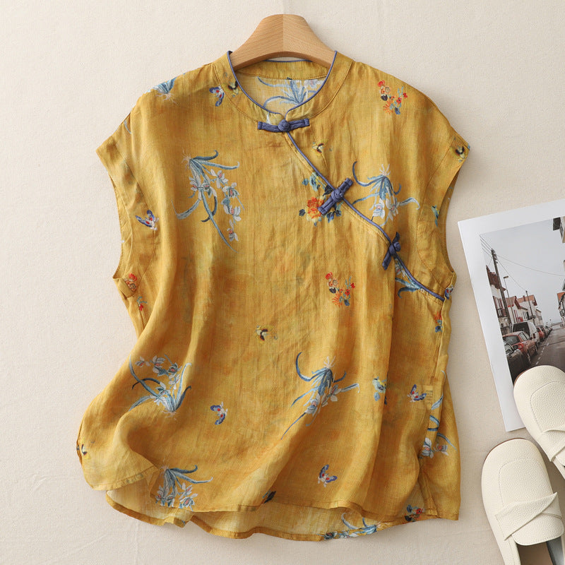 Yellow sleeveless top with blue and orange floral print and traditional frog button closure