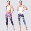 Two models wearing floral and abstract print cropped yoga leggings