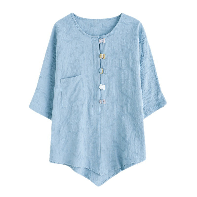 Light blue women's short sleeve shirt with frog buttons and a pocket