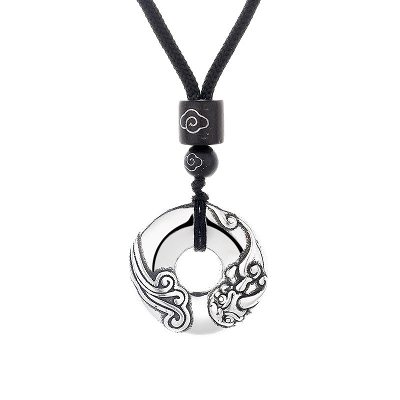 Silver-tone copper pendant with Pixiu design on a black cord