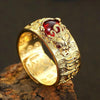Close up of an adjustable metal ring with a Pixiu head and red stone