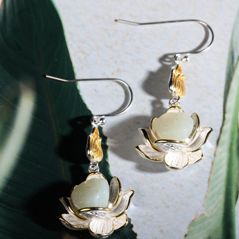 Pair of silver tone lotus flower earrings with a white jade center