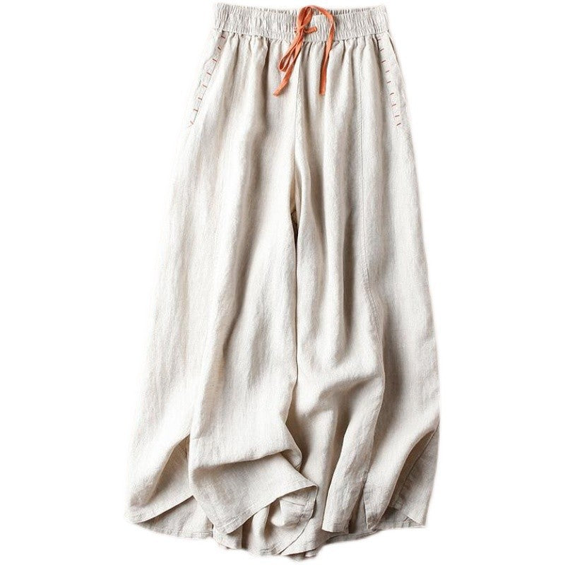 Beige wide leg cotton pants with orange drawstring laid flat