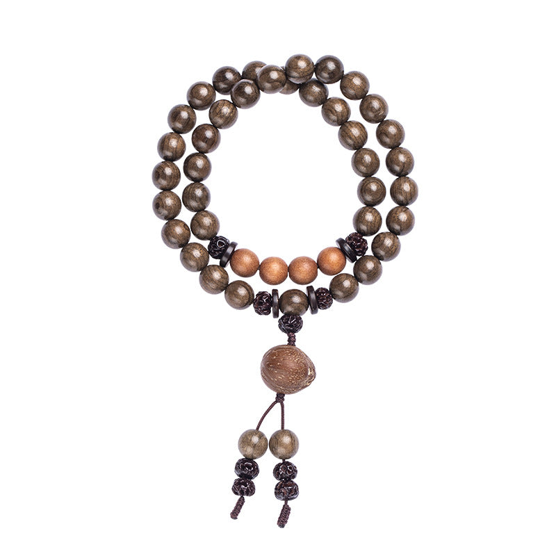 Close-up of a multi-strand wooden bead bracelet with sandalwood accents worn on a wrist.