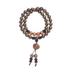Close-up of a multi-strand wooden bead bracelet with sandalwood accents worn on a wrist.