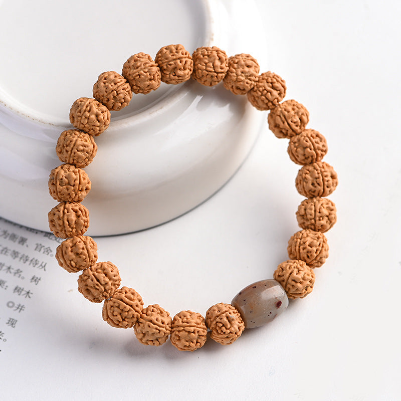 Close-up view of textured brown five-petal rudraksha beads on a bracelet