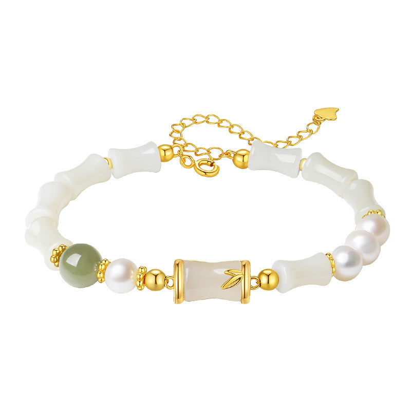 Sterling silver bracelet with white jade bamboo beads and pearl on a wrist