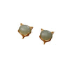 Pair of green jade fox-shaped stud earrings on a wooden surface