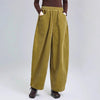 Model wearing mustard yellow wide-leg corduroy harem pants with hands in pockets