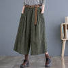 Model wearing green wide leg corduroy pants with hands in pockets