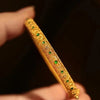 Gold-Tone Filigree Bangle with Green Stones
