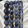 Strands of polished blue natural stone beads on white fabric