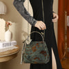Green velvet jacquard handbag with floral embroidery and a metal frame handle