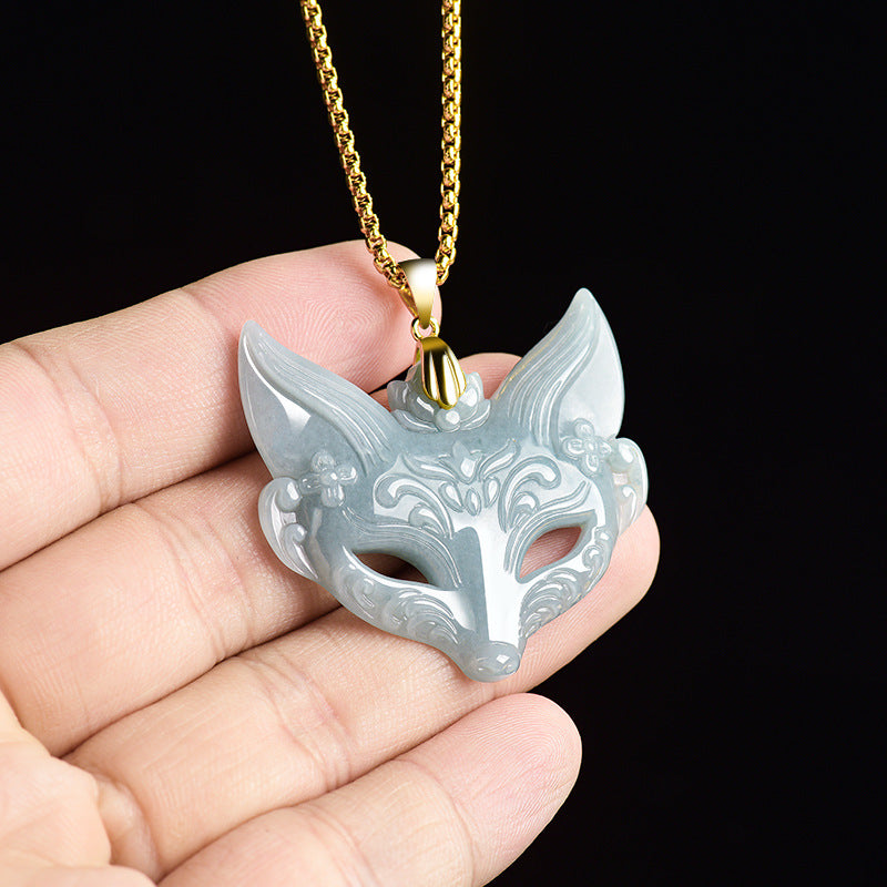 Carved blue water jade fox mask pendant on a gold-tone chain