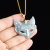 Carved blue water jade fox mask pendant on a gold-tone chain