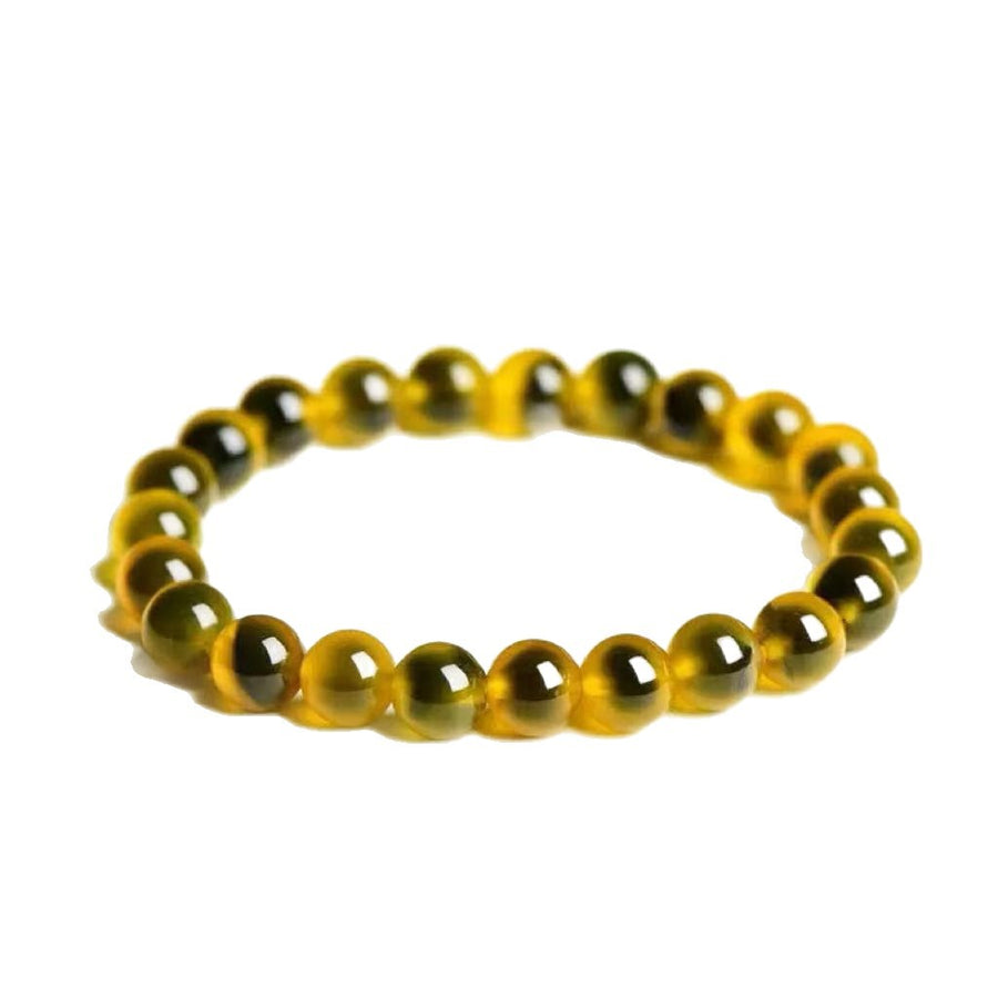 Close up of a yellow agate bead bracelet on a white background