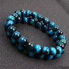 Polished blue tiger eye beaded bracelet on a dark surface