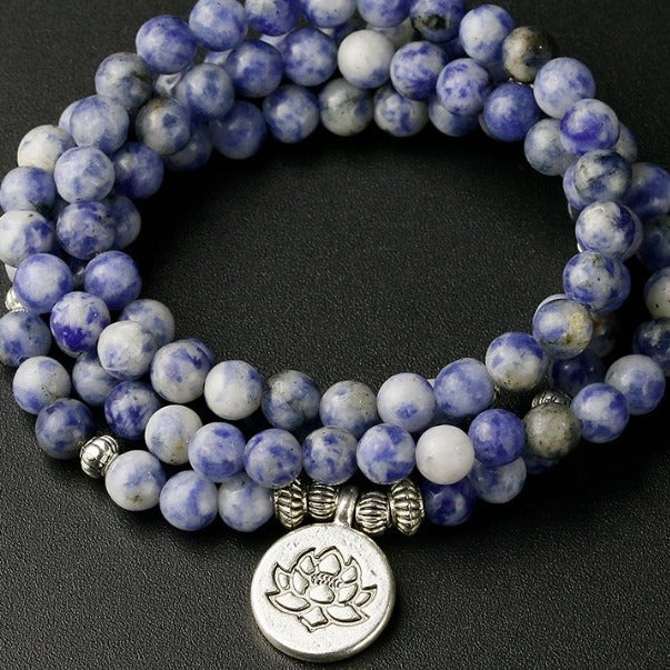 Coiled blue and white marbled stone beads with a silver lotus pendant