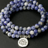 Coiled blue and white marbled stone beads with a silver lotus pendant