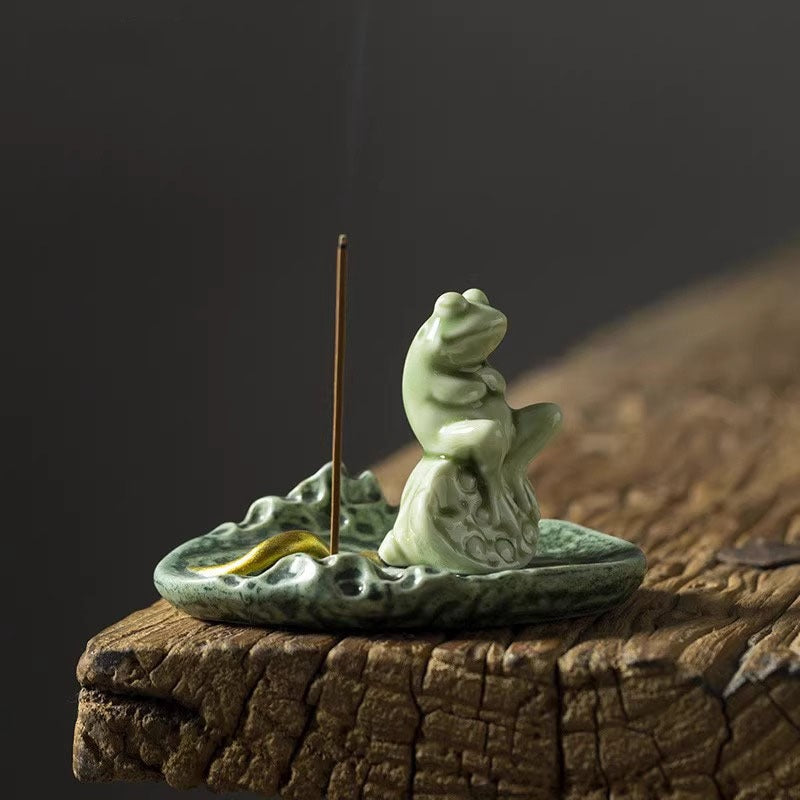 Green ceramic incense burner shaped like a frog on a lily pad