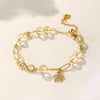 Gold-tone bracelet with clear crystal beads, a Möbius loop, and a star charm on a wrist