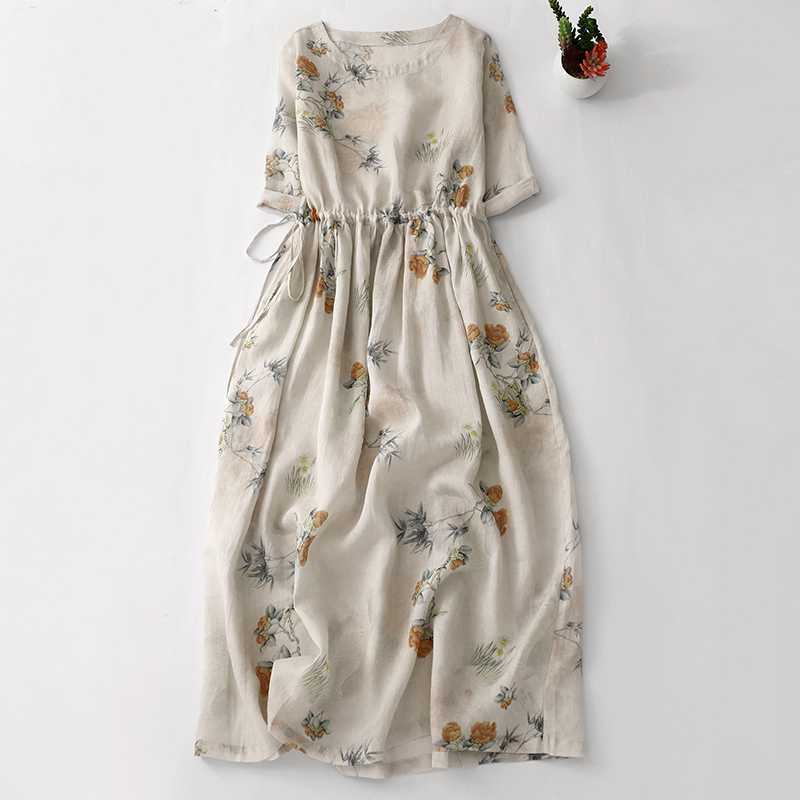 Beige linen midi dress with orange floral print and drawstring waist laid flat on white background