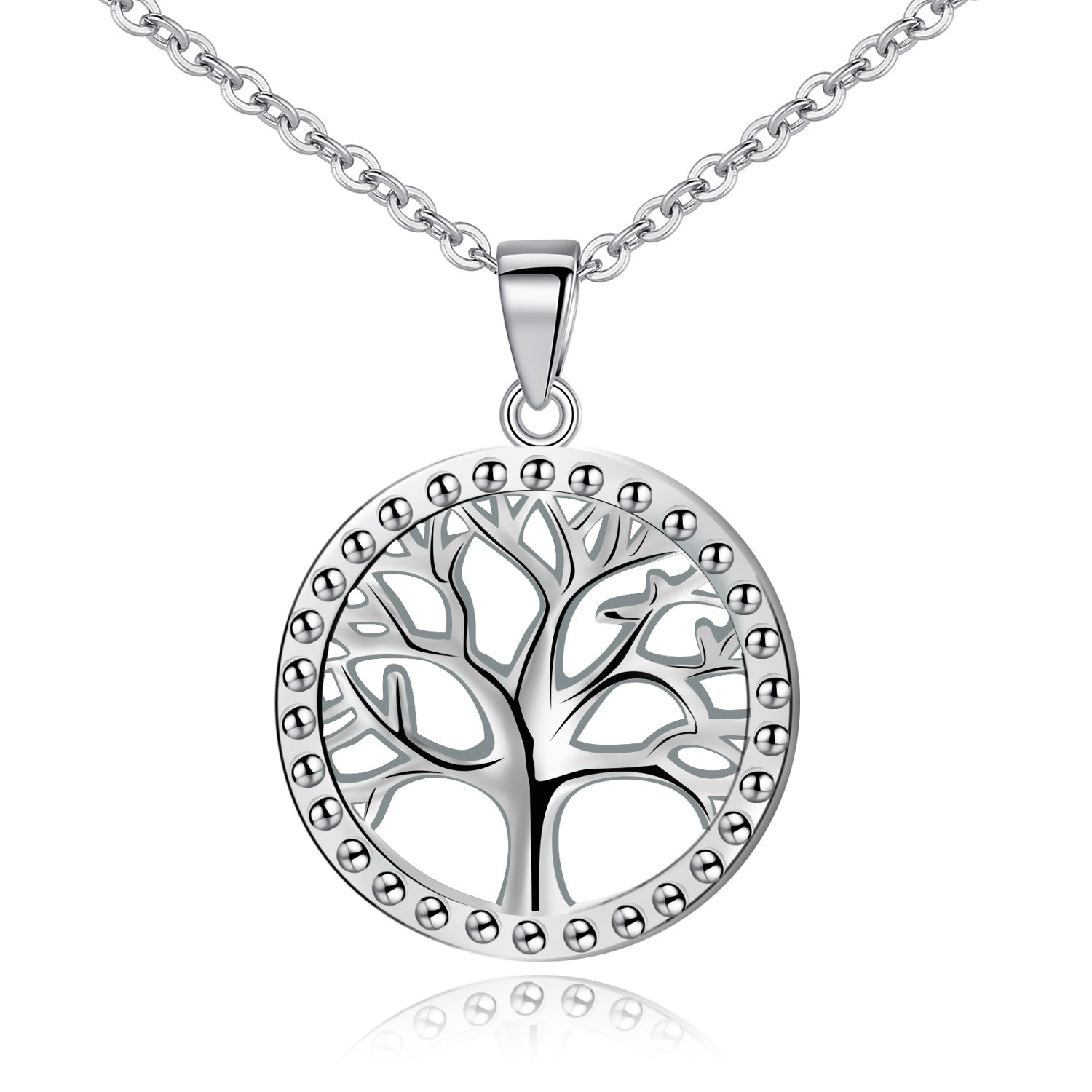 Close up view of a round sterling silver pendant with a tree of life cutout design