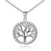 Close up view of a round sterling silver pendant with a tree of life cutout design