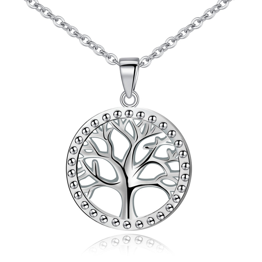 Close up view of a round sterling silver pendant with a tree of life cutout design