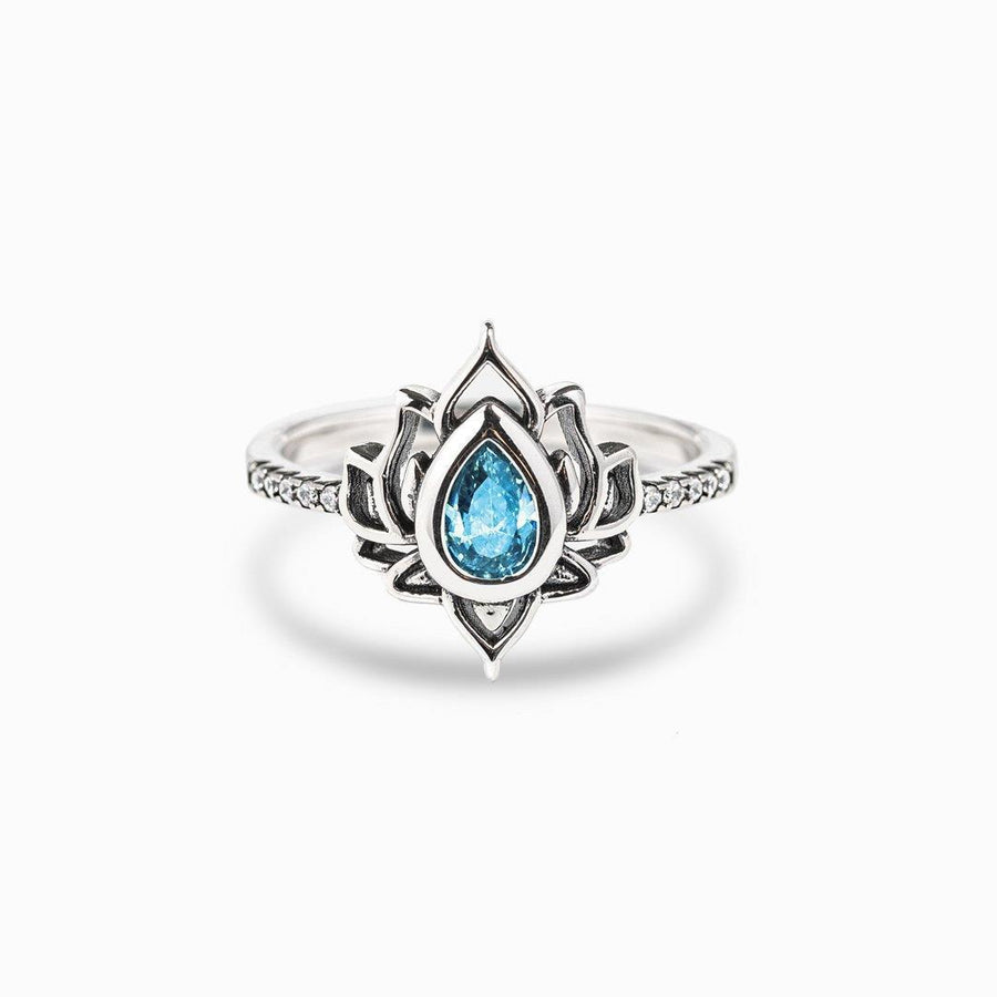 Silver plated lotus flower ring with blue zircon stone on white background