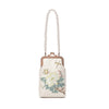 Cream embroidered clutch bag with pearl chain strap held by a woman