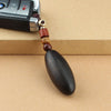 Black ebony wood egg-shaped keychain pendant with brown cord