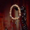 Carved Bone Bead Bracelet with Tassel Charm