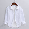 White men's long sleeve linen shirt with turn-down collar hanging on a wooden hanger
